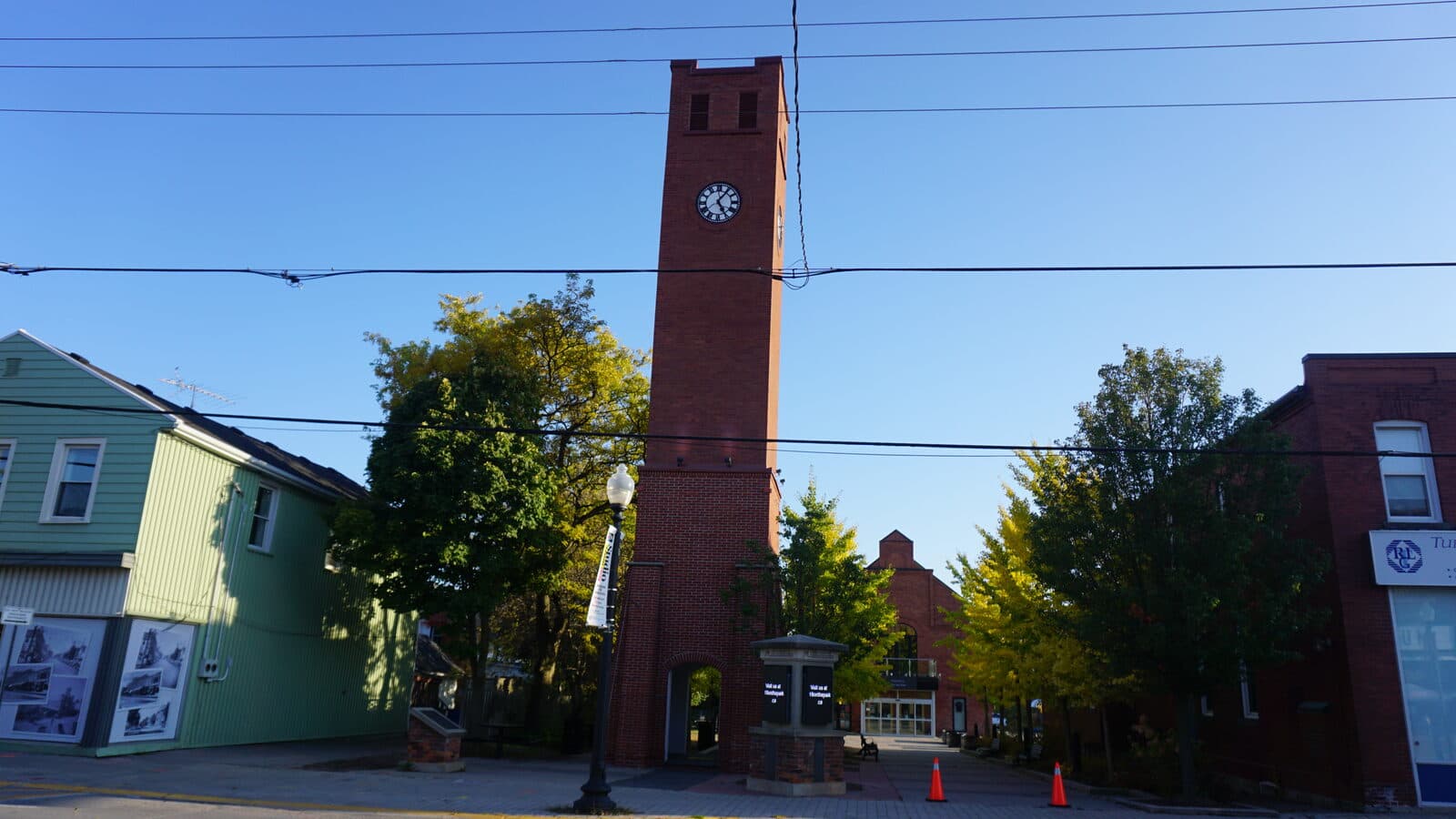 The brick clock tower at Stouffville Civic Square in downtown Stouffville, Ontario on a bright autumn day