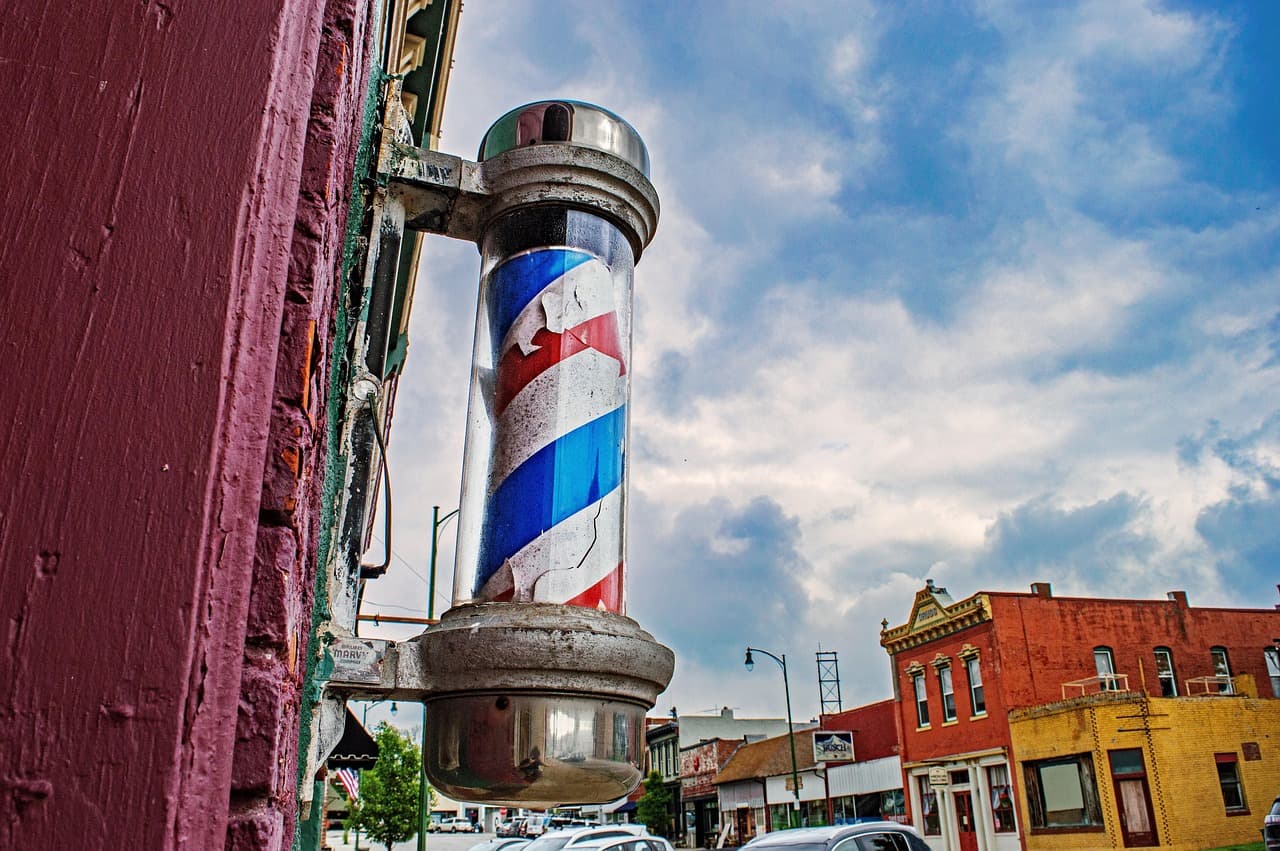 Vintage barber pole and heritage brick storefronts on a small-town main street, representative of Stouffville